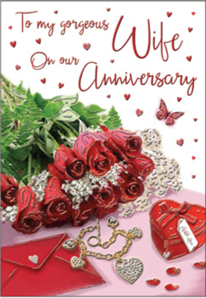 In this richly composed anniversary scene, a bouquet of classic red roses becomes the unmistakable focal point, as though just arranged by an experienced florist in Northwood for a special evening at home. The roses are lavishly full, each head round and generous, with petals unfolding in deep crimson waves that suggest passion, loyalty, and years of companionship. Subtle variations in the red tones catch the gentle light, from ruby highlights at the tips to wine-dark shadows nestled near the centres. Lush green foliage interlaces between the blooms, offering contrast and a sense of freshness that brings to mind the leafy character of Northwood's parks and gardens. Resting nearby is an anniversary card with an elegant envelope, both aligned at a slight angle to one another for a relaxed, natural feel. The card's front is adorned with flowing script and scattered hearts, echoing the romantic mood of the flowers. A jewellery set-perhaps a pendant and chain-lies beside a small, vivid red heart box, both items glinting softly as light bounces off polished metal and smooth surfaces. Tiny heart-shaped accents and a lone butterfly motif dot the surrounding area, like confetti waiting to be gently brushed aside after the surprise is revealed. The lighting is soft, reminiscent of daylight filtering through a Northwood bay window, adding a serene glow to every texture: the velvety roses, the crisp card, and the sleek gleam of jewellery. This arrangement captures the feeling of a private celebration, the kind that might unfold quietly in a Northwood home off Rickmansworth Road, where shared stories, laughter, and memories gather around a simple yet meaningful display of roses, keepsakes, and loving words.
